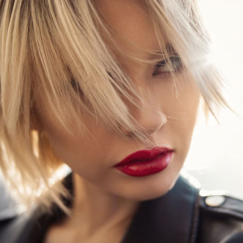 woman who wears great make-up with strong lipstick and fair hair hairstyling